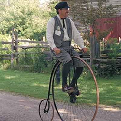 Riding an antique bike in Pioneer Village